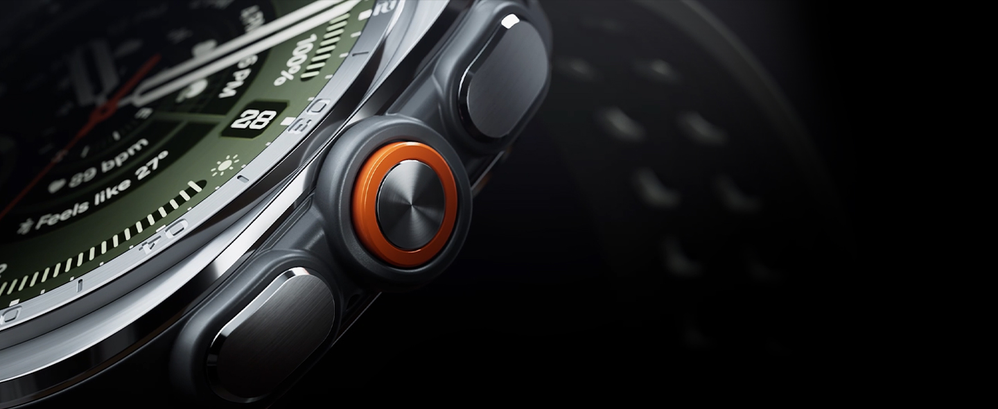 Close-up view of the boldly designed, intuitive buttons and the orange Quick Button on the side of a Galaxy Watch Ultra2 in Titanium Silver with a Marine Band in Olive, shown at an angle.