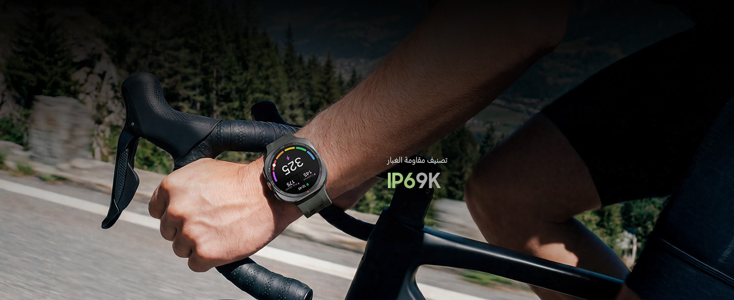 A cyclist is riding a bike on a road in the mountains while wearing a Galaxy Watch Ultra2 in Titanium Silver with a Marine Band in Olive displaying a personalized Functional Threshold Power with cadence and average power.