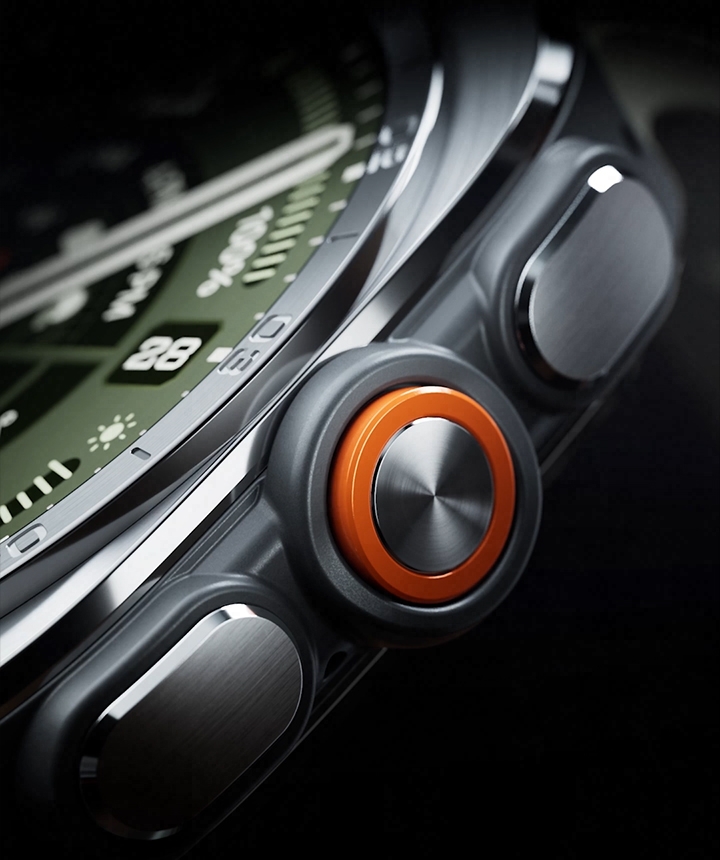 Close-up view of the boldly designed, intuitive buttons and the orange Quick Button on the side of a Galaxy Watch Ultra2 in Titanium Silver with a Marine Band in Olive, shown at an angle.