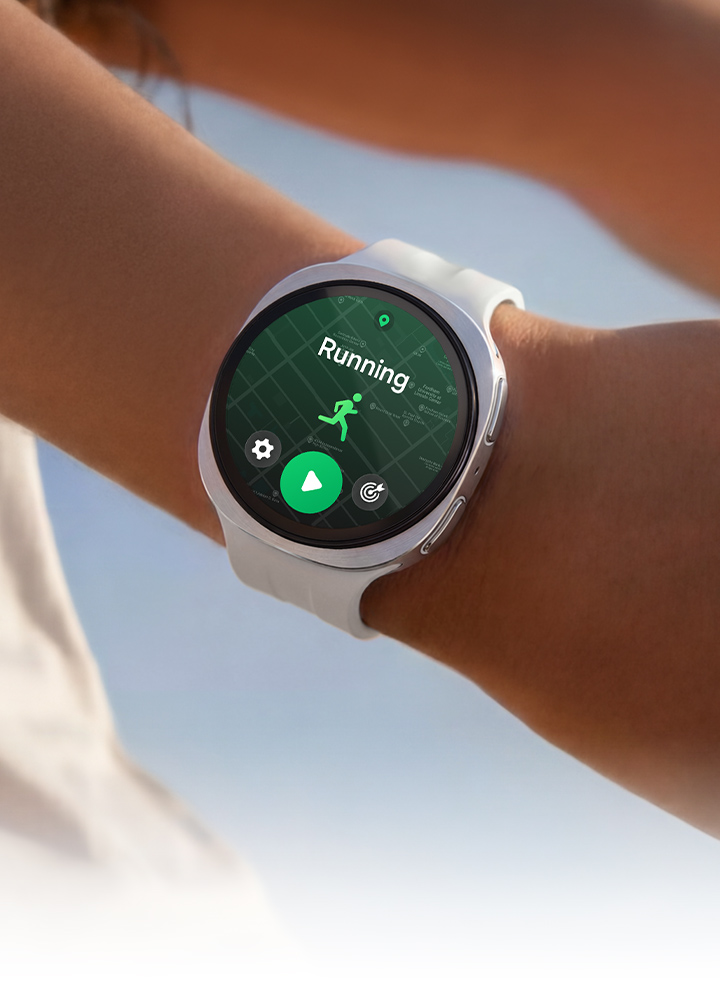 A person is wearing Galaxy Watch9 in Cream with a Sport Band in Cream while stretching their arms and a running training program is open on the watch display.