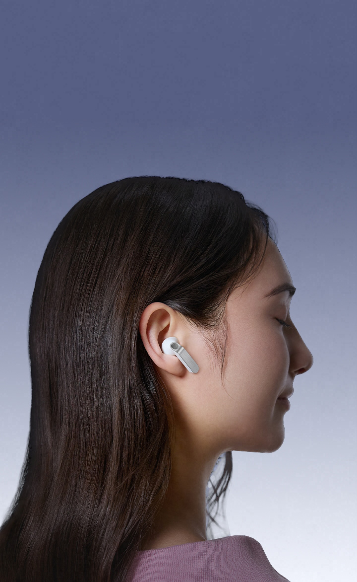 White Galaxy Buds4 earbuds in close-up, showcasing the real metal blades in different angles. Scene changes and a person is wearing Galaxy Buds4 in White, facing the right.