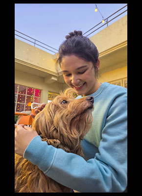 Portrait of a woman and a dog outdoors. Skin tones and textures are well captured.